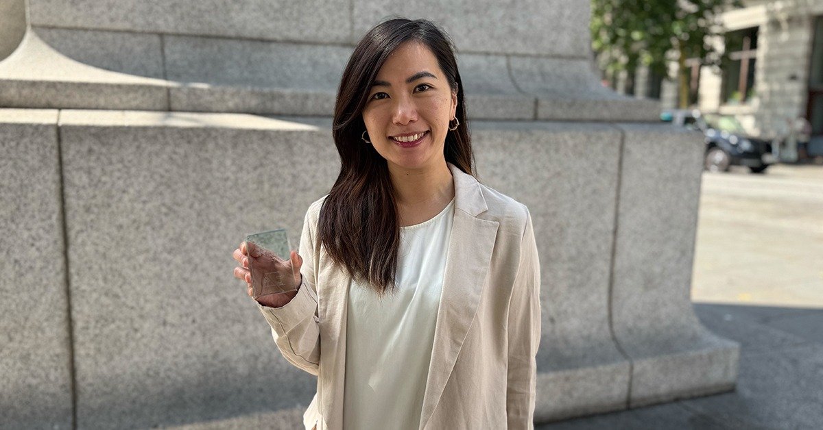 Gemma Fong holding her award in her right hand